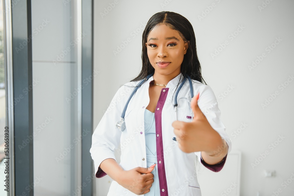 Portrait Of Smiling Female Doctor Wearing White Coat With Stethoscope In Hospital Office Portrait Of Smiling Female Doctor Wearing White Coat With Stethoscope In Hospital Office