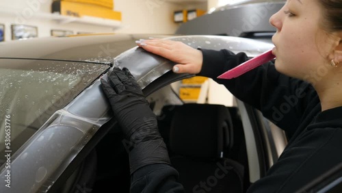 Close up to PPF installation process on a front headlight and hood. PPF is a Paint Protection Film which protect paint from scratches and stone chips. Concept of: Guard, Protect, Car, New, Work.