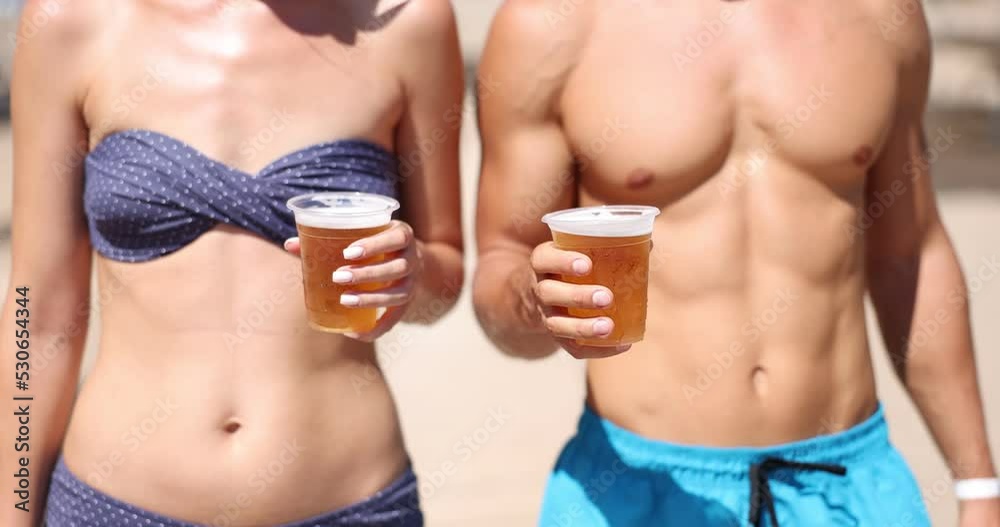 Man and woman are holding glasses of cold refreshing beer