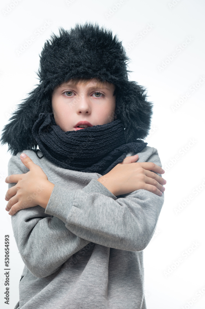 Winter hat with earflaps and scarf, portrait of a boy in winter clothes. Winter hat with earflaps and scarf, portrait of a boy in winter clothes.