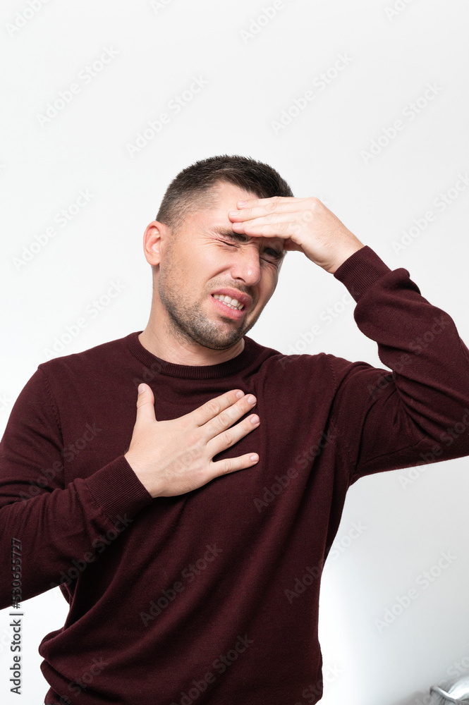 Emotions of a man from a headache, a man suffers from the pain of a severe migraine. Emotions of a man from a headache, a man suffers from the pain of a severe migraine.