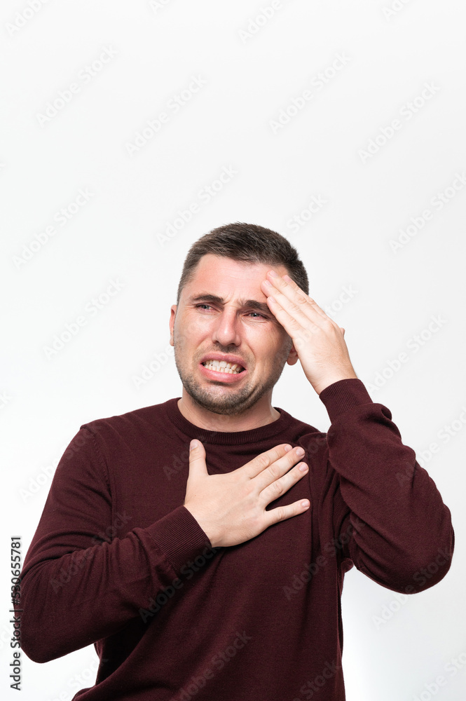 Emotions of a man from a headache, a man suffers from the pain of a severe migraine. Emotions of a man from a headache, a man suffers from the pain of a severe migraine.