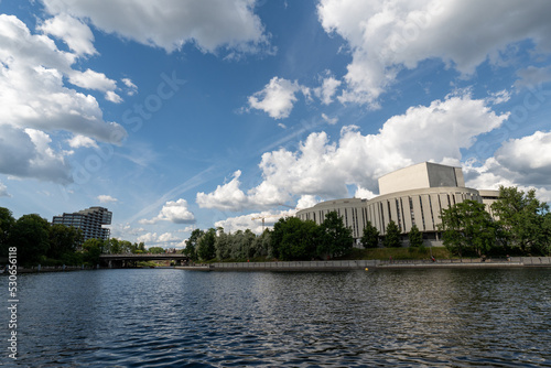 View across the Brda River, of the Opera Nova building in Bydgoszcz and the Nordic Haven skyscraper, from the side of Mill Island 