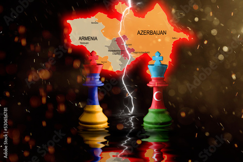 armenia and azerbaijan flags paint over on chess king. 3D illustration. armenia azerbaijan disputed territory map behind. photo
