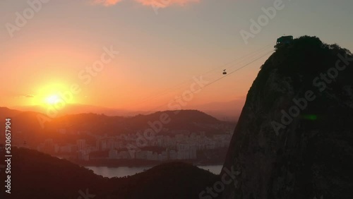 Aerial View of Sugarloaf Mountain in Rio de Janeiro at Sunset.
Beautiful City Skyline, Cable Car Passing Backlit.