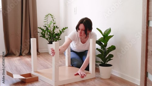 Woman herself assembled a coffee table sitting on the floor and is very happy about it