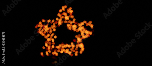 Banner. Isolated black background, blurred bokeh fireworks with warm golden lights in the shape of a star. With a space to copy, overlay for your design. High quality photo