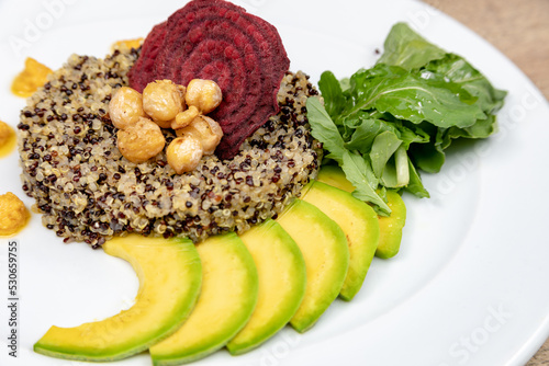 Vegetarian dishes such as salads, quinoa, avocado, vegetables and wraps photo