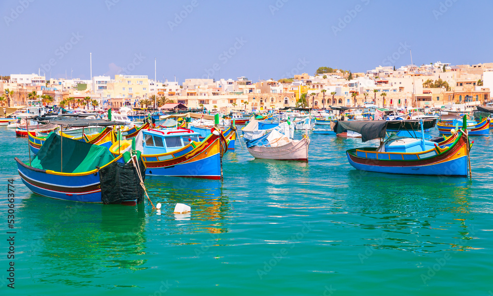 Colorful traditional Maltese fishing boats. Marsaxlokk, Malta