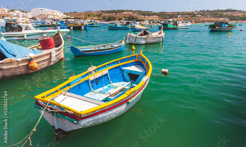 Small colorful Maltese fishing boats moored in Marsaxlokk © evannovostro