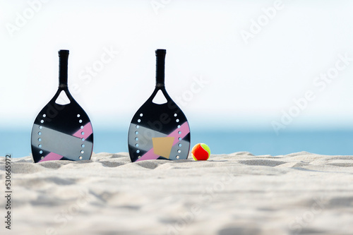 Racket and ball on the sandy beach. Summer sport concept. Horizontal sport theme poster, greeting cards, headers, website and app