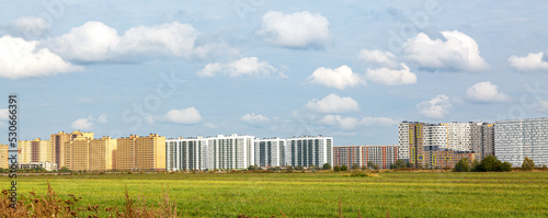 Multi-storey buildings on the background of the sky with clouds. Banner. Background image.