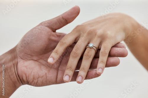 Marriage  jewellery and wedding ring with hands of couple for love  celebration and announcement together. Save the date  engagement and proposal with diamond jewelry on finger of bride