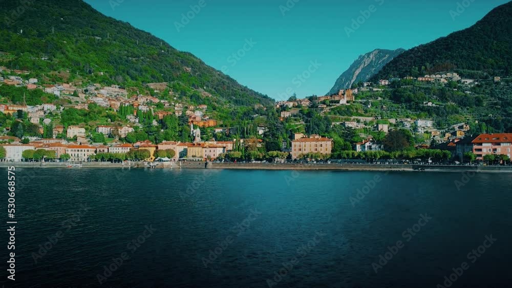 Aerial view of Lake Como. city center. A local ferry arrives in the city. Bell tower. Tourism and romance. Mountains around the lake. Red roofs. Green Planet. Sailing yacht. Italy, Bellano, 09.2022 Aerial view of Lake Como. city center. A local ferry arrives in the city. Bell tower. Tourism and romance. Mountains around the lake. Red roofs. Green Planet. Sailing yacht. Italy, Bellano, 09.2022