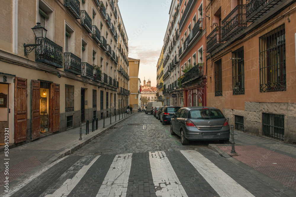 Facades of old urban residential buildings in a narrow street in the historic center of Madrid