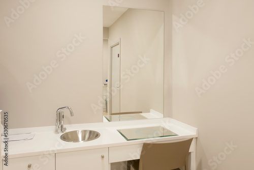 A makeup table with sink and frameless mirror on the wall © Toyakisfoto.photos