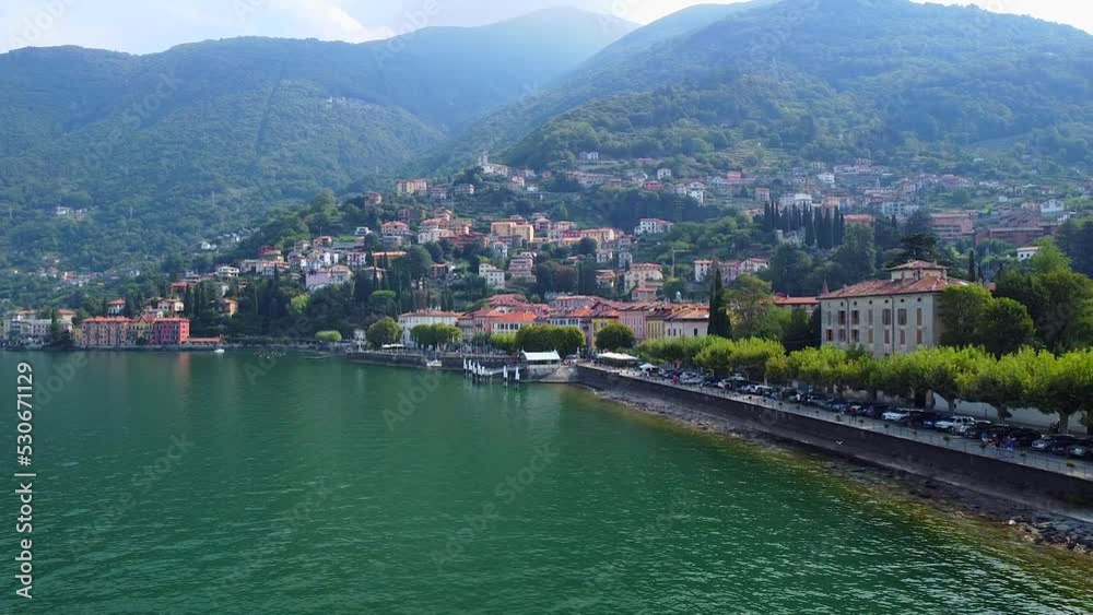 Aerial view of Lake Como. city center. A local ferry arrives in the city. Bell tower. Tourism and romance. Mountains around the lake. Red roofs. Green Planet. Sailing yacht. Italy, Bellano, 09.2022 Aerial view of Lake Como. city center. A local ferry arrives in the city. Bell tower. Tourism and romance. Mountains around the lake. Red roofs. Green Planet. Sailing yacht. Italy, Bellano, 09.2022