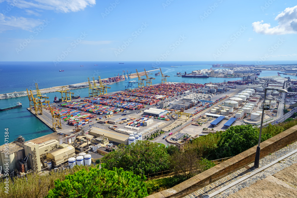 Panoramic view of the port of Barcelona with merchant ships and cargo containers, Spain.