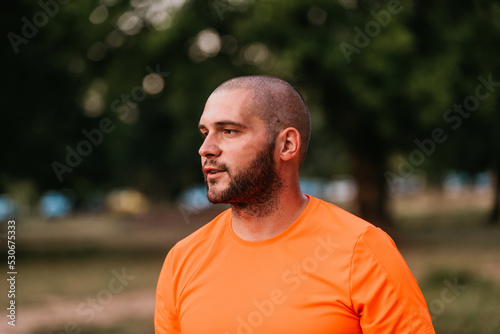 headshot of a man standing in a parka after training