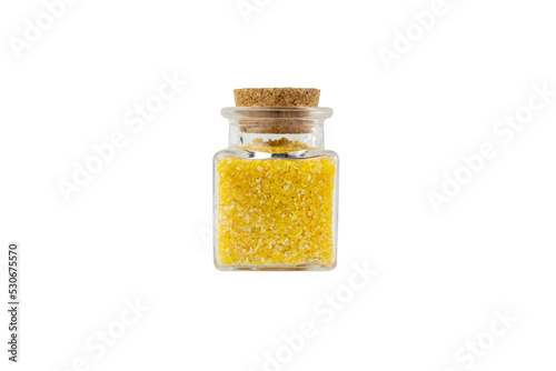 corn grits in a glass jar isolated on white background. nutrition. food ingredient.
