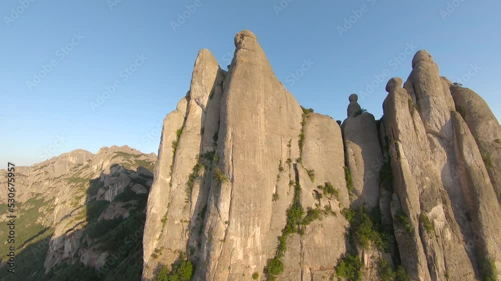 Fast extreme close dive, drop down, steep rocky mountains, cliff top slopes and scenic rock canyon on sunny day, racing drone, first point of bird's eye view. Mountains of Spain Fast extreme close dive, drop down, steep rocky mountains, cliff top slopes and scenic rock canyon on sunny day, racing drone, first point of bird's eye view. Mountains of Spain