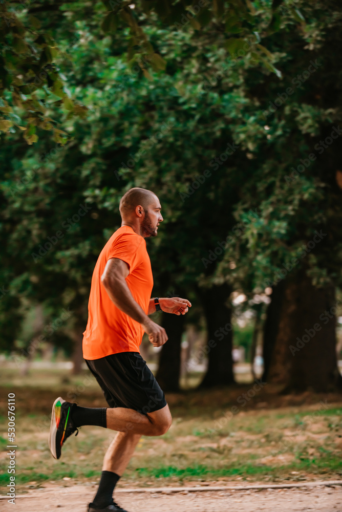 Athletic young man running in nature. Healthy lifestyle Athletic young man running in nature. Healthy lifestyle