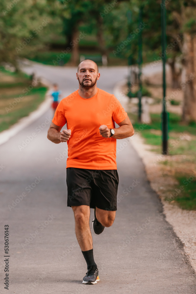 Athletic young man running in nature. Healthy lifestyle Athletic young man running in nature. Healthy lifestyle