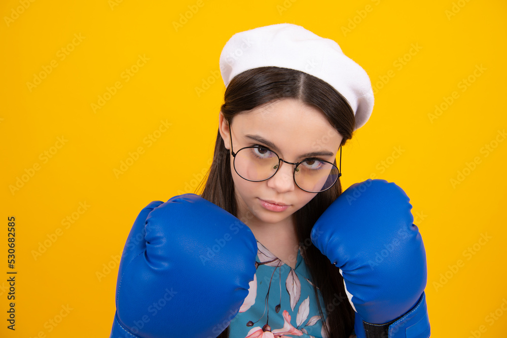 Teenage fun boxer girl in boxing gloves on yellow isolated background. Funny girl boxer in fun gloves boxing, studio shot isolated on yellow background. Teenage fun boxer girl in boxing gloves on yellow isolated background. Funny girl boxer in fun gloves boxing, studio shot isolated on yellow background.