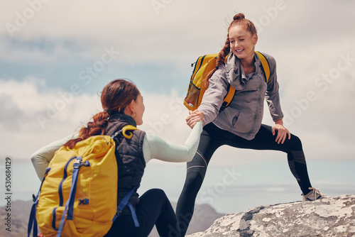 Help hands, friends or women hiking up a mountain, hill or in nature with a smile. Travel, adventure and trekking females on an outdoor, countryside or rock climbing recreation exercise activity.