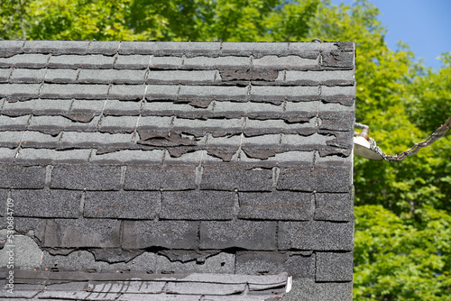 A badly damaged shingles roof