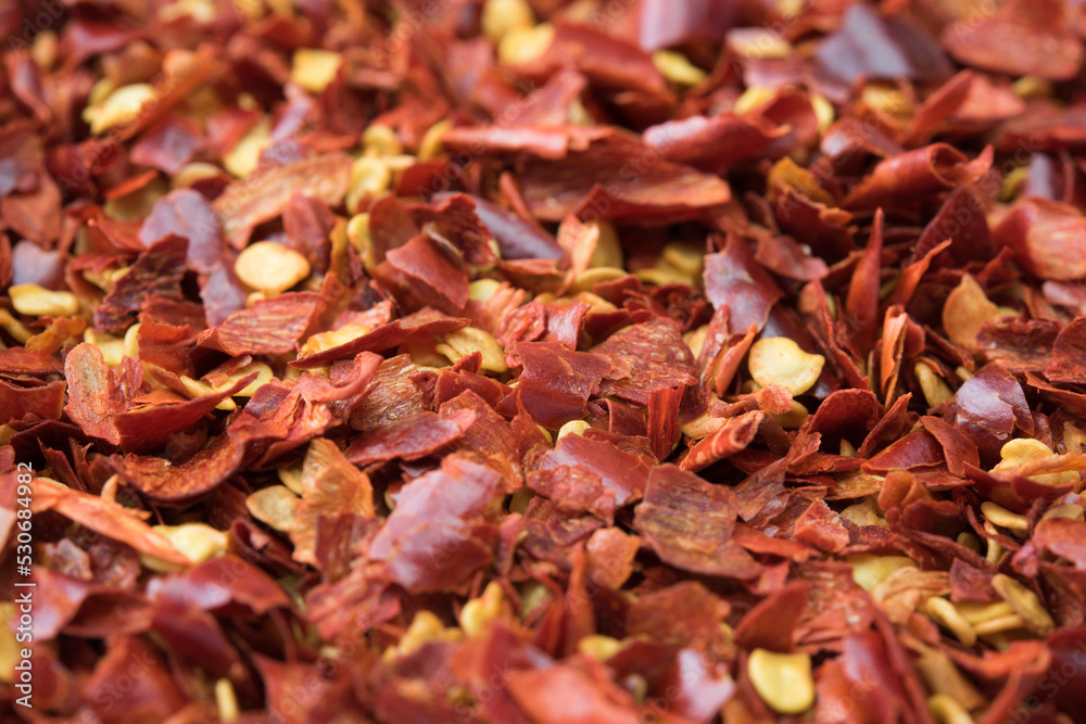 Crushed red pepper, close-up, with depth. In realistic color. Shallow depth of field. Crushed red pepper, close-up, with depth. In realistic color. Shallow depth of field.