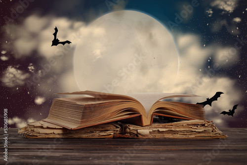 Принти на полотні Old books on table at night. Halloween celebration