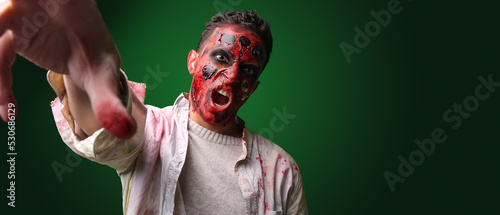 Scary zombie man on dark gr...