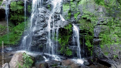 Ascending view of the beautiful and touristic waterfall known as Fervenza das hortas, located in Galicia. 4k resolution