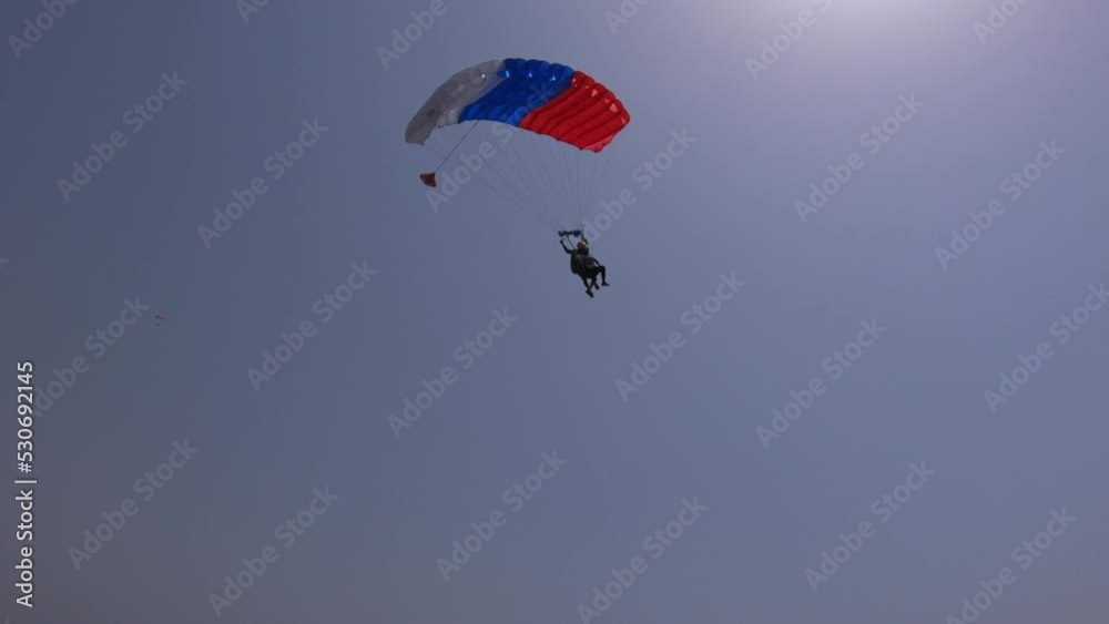 tandem parachute is landing, cloudy weather tandem parachute is landing, cloudy weather