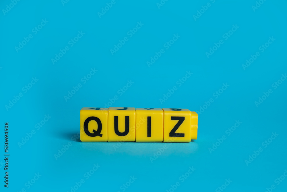 Yellow cubes with word Quiz on light blue background. Space for text Yellow cubes with word Quiz on light blue background. Space for text
