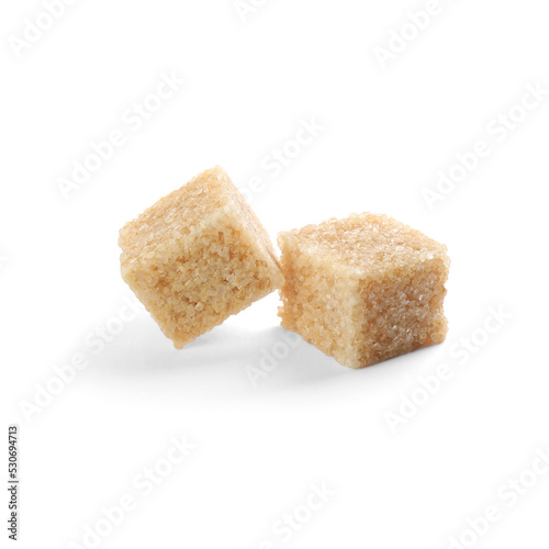 Two brown sugar cubes isolated on white