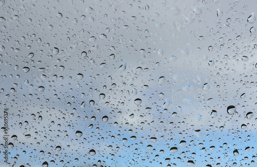 water drops on glass with view of sky and cloud