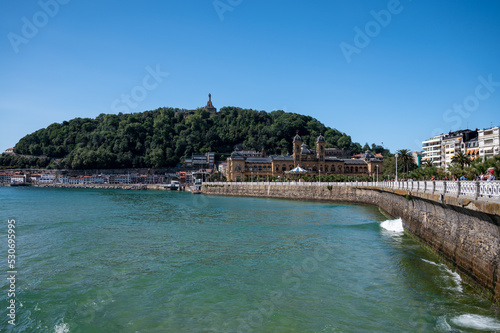 Walking near La Concha sandy beach in San Sebastian or Donostia city  touristic destination in Basque Country  north of Spain