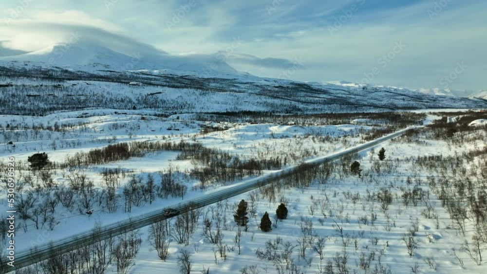 Aerial view following a car driving in boreal wilderness of Norway - tracking, drone shot Aerial view following a car driving in boreal wilderness of Norway - tracking, drone shot