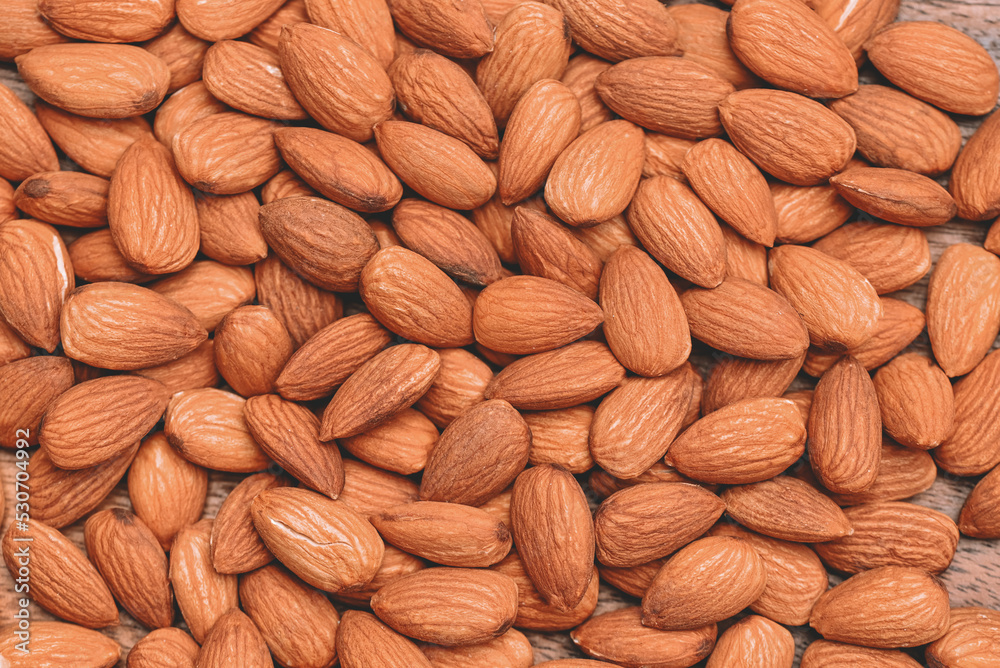 Almonds nuts on background, Close up delicious sweet almonds, roasted almond nut for healthy food and snack Almonds nuts on background, Close up delicious sweet almonds, roasted almond nut for healthy food and snack