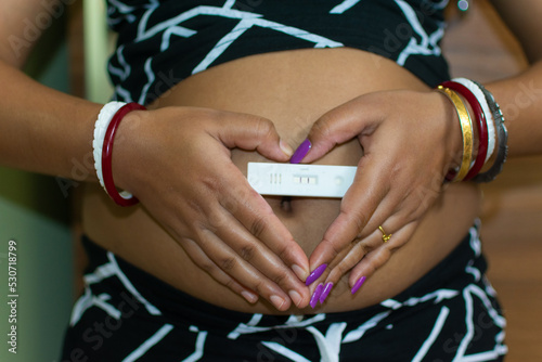 Vászonkép Pregnant Indian woman showing positive pregnancy test