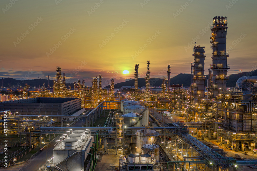 Fototapeta premium Oil and gas refinery plant form industry zone at night, Aerial view oil and gas Industrial petrochemical fuel power and energy.