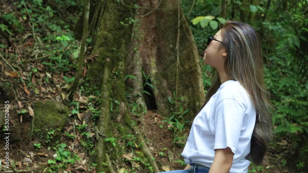A Young Woman Staring to the Scenery in Front of Her A Young Woman Staring to the Scenery in Front of Her