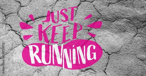 Composition of just keep running slogan in pink and white with footprint, on grey cracked earth