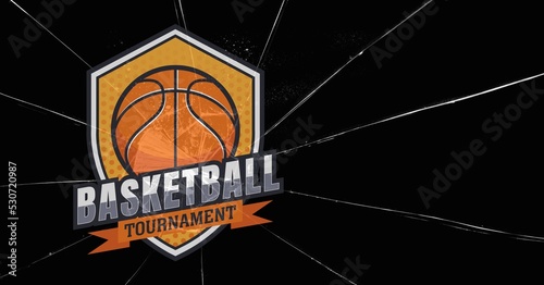 Composition of orange and white basketball tournament shield design, on broken glass and black