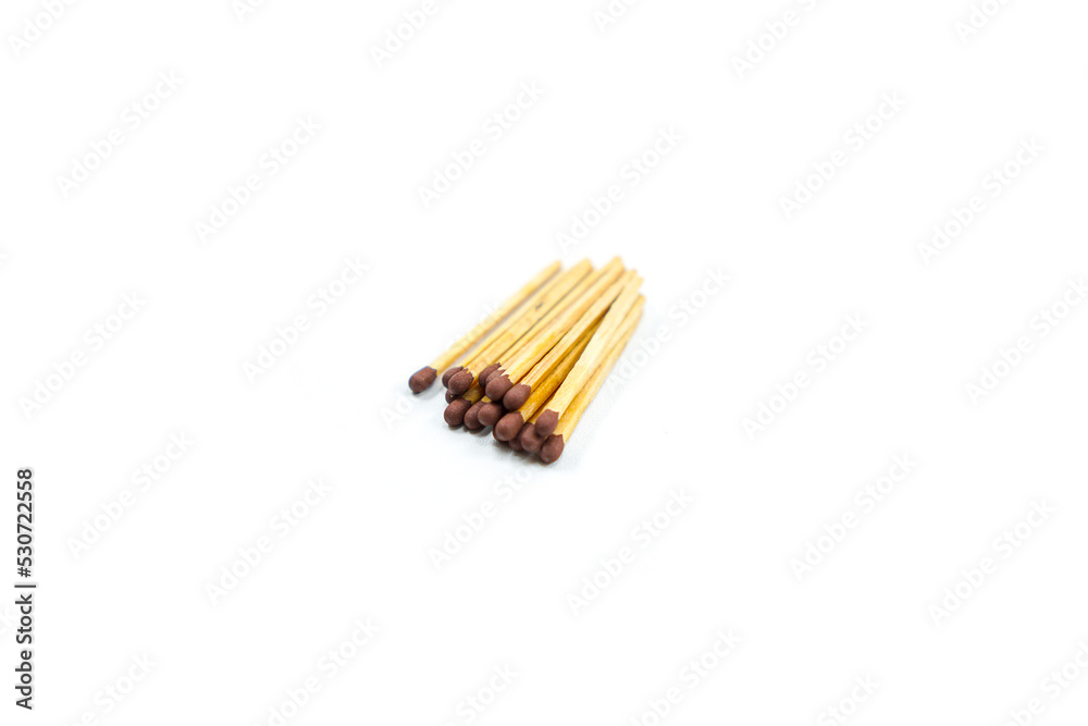 a collection of matchsticks neatly arranged isolated on a white a collection of matchsticks neatly arranged isolated on a white