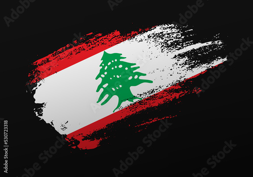 Abstract creative patriotic hand painted stain brush flag of Lebanon on black background