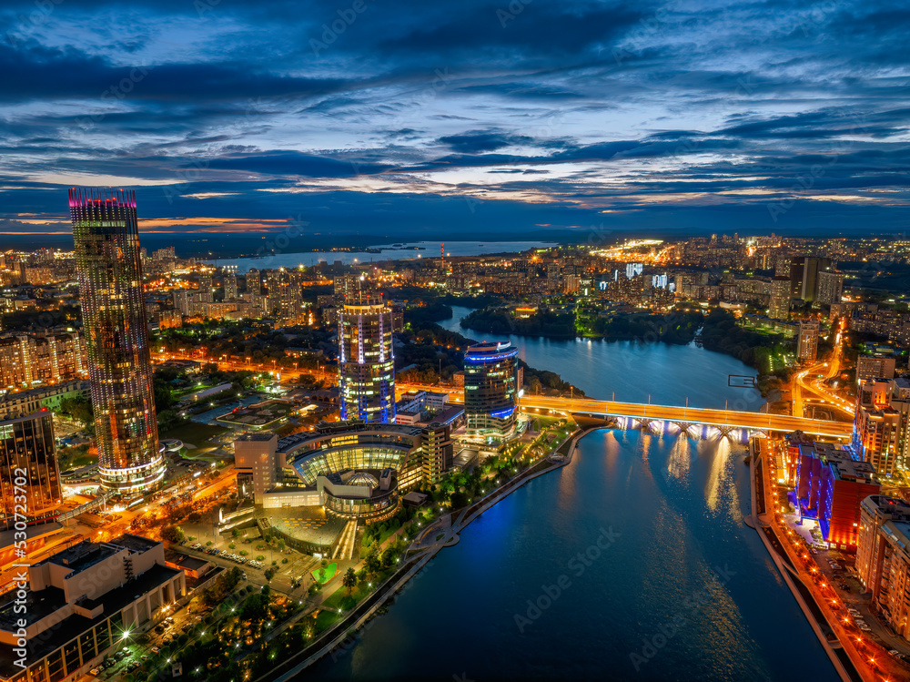Yekaterinburg city and pond aerial panoramic view at summer or early autumn night. Night city in the early autumn or summer. Yekaterinburg city and pond aerial panoramic view at summer or early autumn night. Night city in the early autumn or summer.