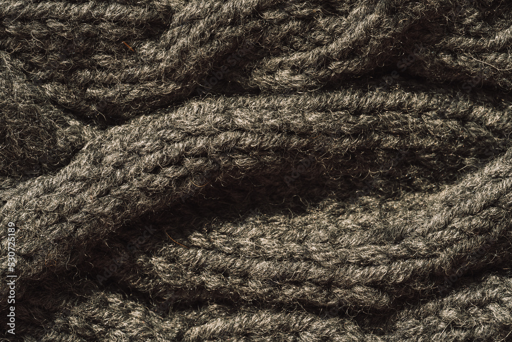 Background of gray knitted woolen thread close-up. Background of gray knitted woolen thread close-up.